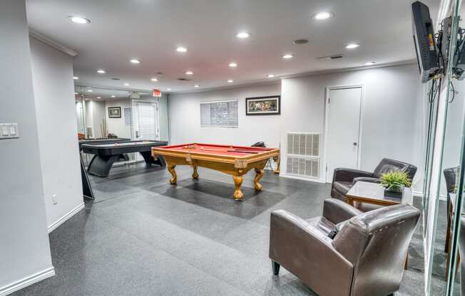 a games room with a pool table and ping pong