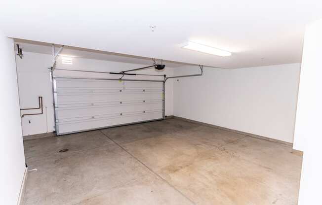 the inside of a garage with a white door at The Vines at Riverpark, LLC, California, 93036