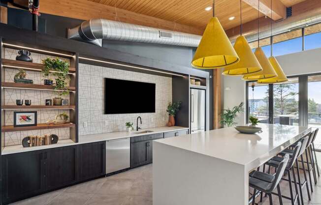 A modern kitchen with a white countertop and black cabinets.