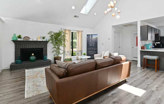 a living room with a leather couch and a fireplace