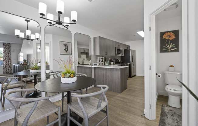 a living room and kitchen with a table and chairs