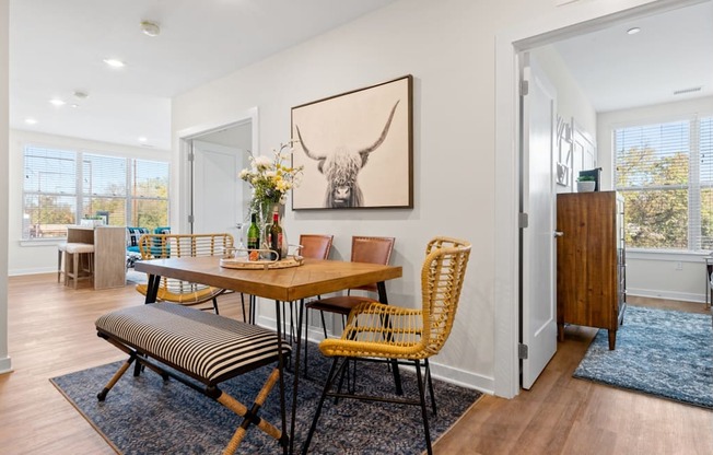 A dining room with a wooden table and chairs.