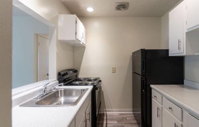 This is a photo the kitchen with white cabinets in the 925 square foot, Hazelnut 2 bedroom, 1 bath apartment at Montana Valley Apartments in the Westwood neighborhood of Cincinnati, OH.