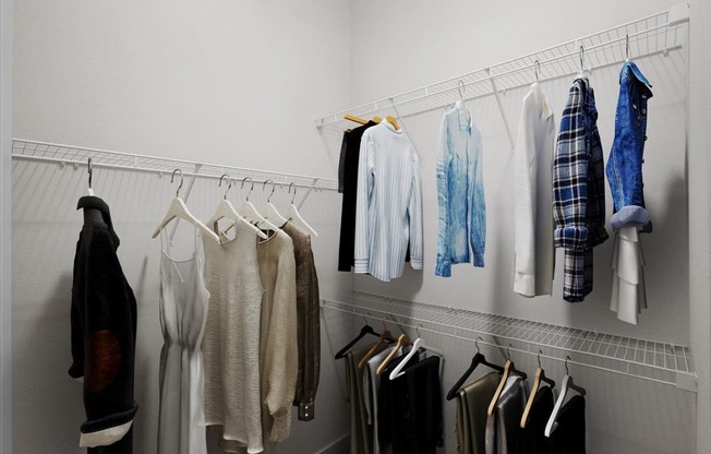a rack of clothes hanging in a closet