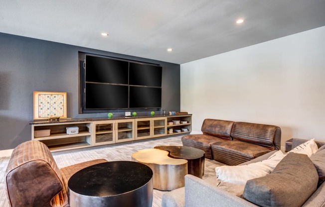 a living room filled with furniture and a large flat screen tv