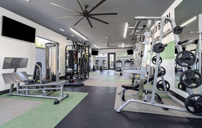 a gym with weights and cardio equipment at the flats