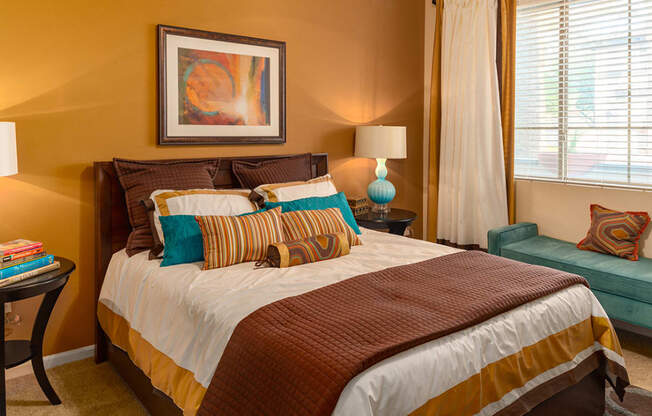 a bedroom with a bed and a chair in a 555 waverly unit