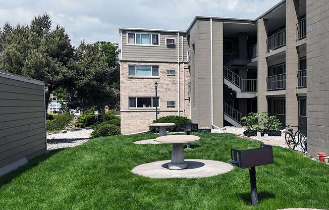 A modern building with a green lawn in front.