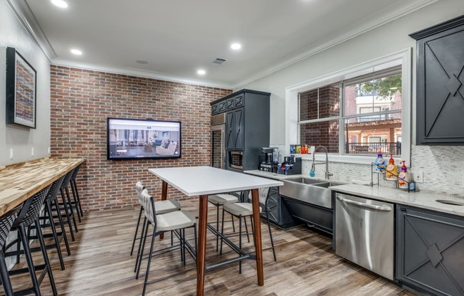 a kitchen with stainless steel appliances and a table with chairs