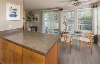 a kitchen and dining room with a glass table and chairs