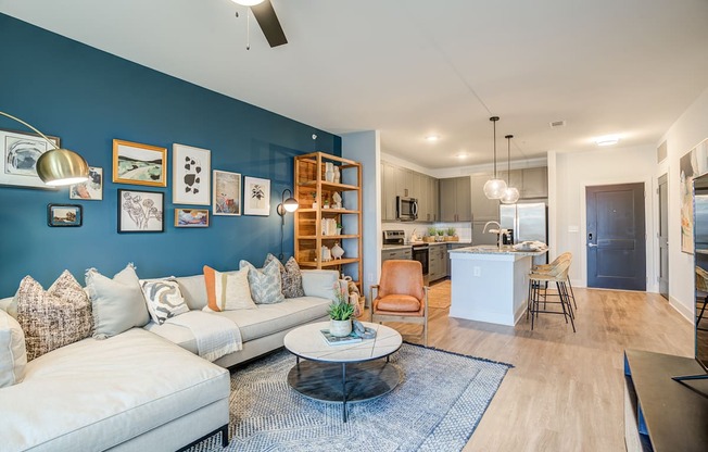 a living room with a blue accent wall and a white couch
