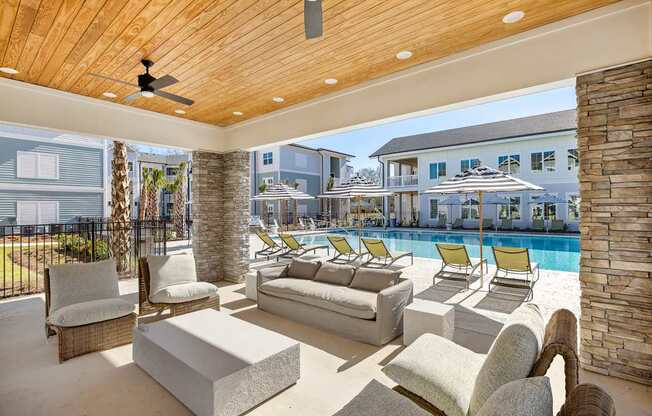 A modern outdoor living space with a pool and lounge chairs.