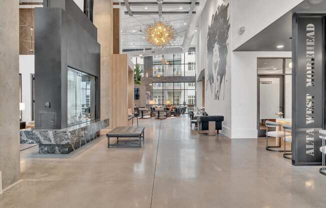 a lobby with a fireplace and tables and chairs