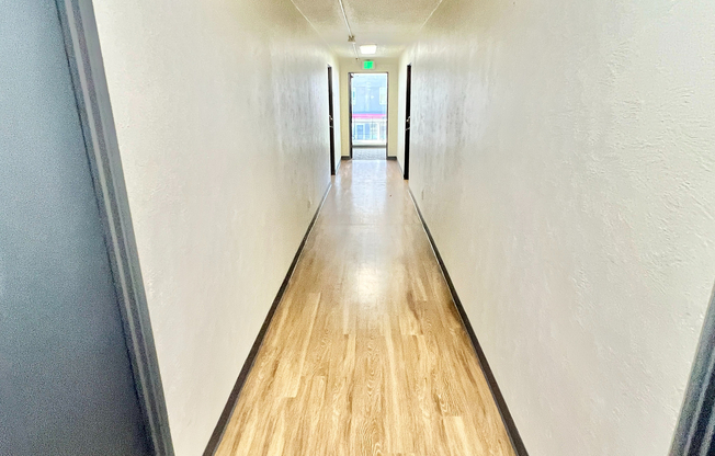 Experience the elegance of this well-lit hallway, perfect for a welcoming entrance.