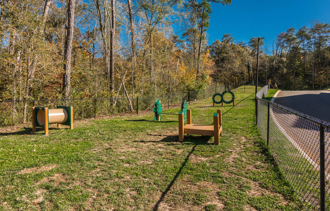 a dog park with agility equipment and a fence at Village at Westland Cove Apartments, Tennessee