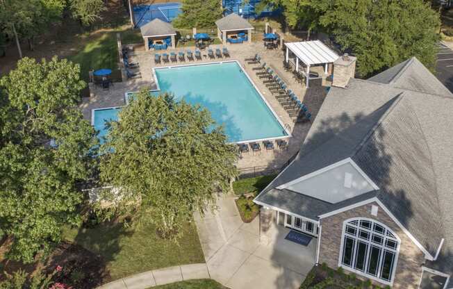 a birdseye view of a pool and a house in a backyard with trees at Trails at Short Pump Apartments, Virginia, 23233