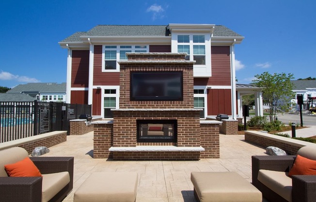 Outdoor lounge with fireplace and flatscreen TV