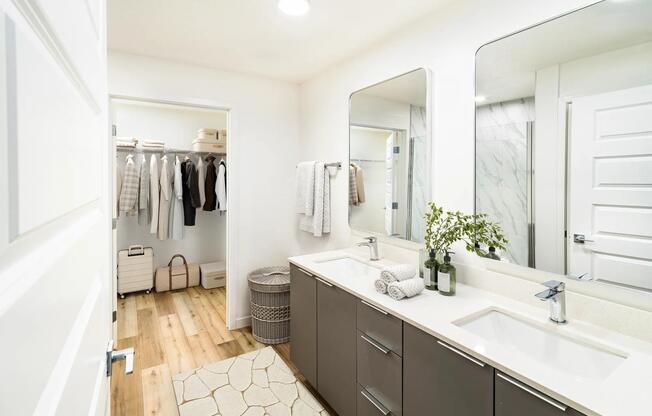 A bright primary bath with generous storage and a spacious closet, offering refined comfort at Modera Encore.