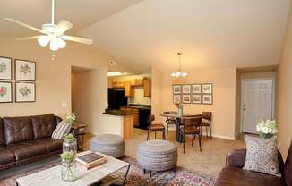 A living room with a brown leather couch and a white coffee table.