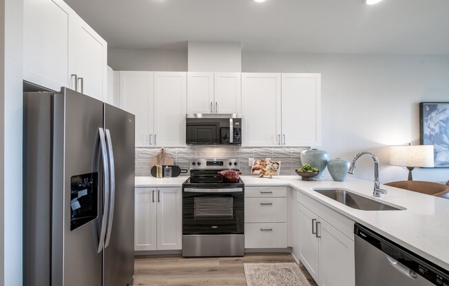 Step into the modern elegance of Sage at Celina Residences. This stunning kitchen features sleek appliances, ample storage, and a vibrant design perfect for culinary creativity. Make this inviting space your own—schedule a tour today!