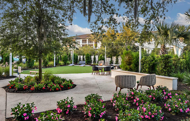 a patio with tables and chairs in a garden