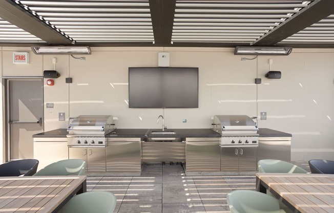 a kitchen with two stoves and two tables at Platform 4611, Chicago, IL 60640