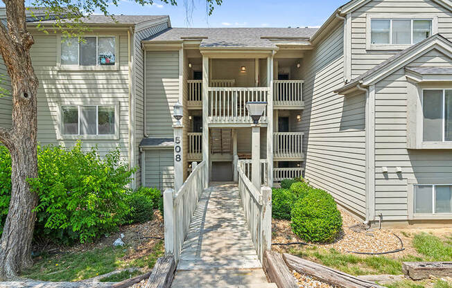 an apartment building with a porch and a walkway