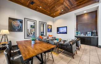 A modern dining room with a wooden table and chairs.