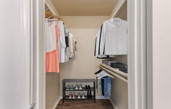 White closet with clothes hanging at Great Hills, Texas, 78759