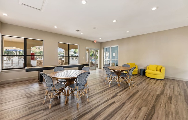 a dining room with a table and chairs and a large window