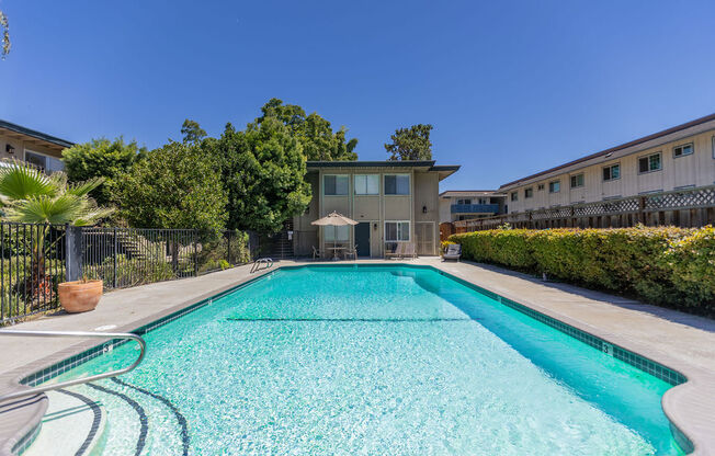 a swimming pool with a building in the background