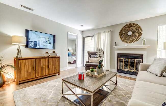 A modern living room with a fireplace and a flat screen TV.