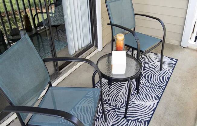 A candle is lit on a table outside at The Madison Apartments and Townhomes, Lawrenceville