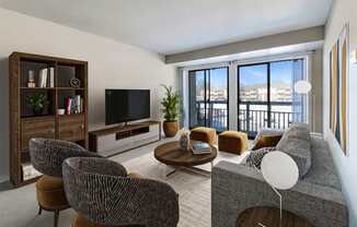 A living room with a grey couch, a coffee table, and a television.
