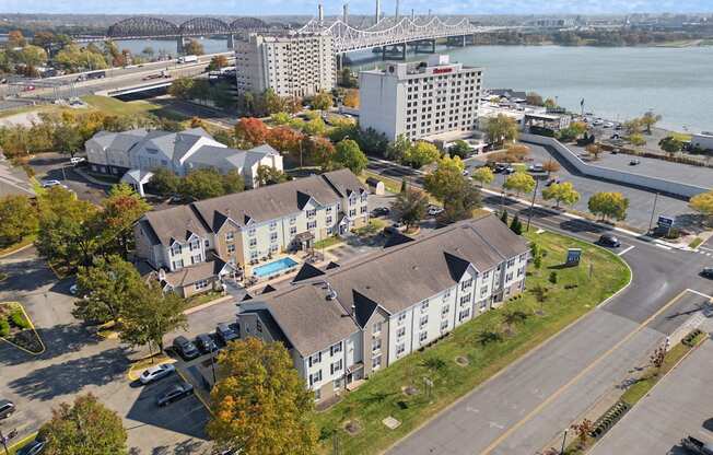 an aerial view of houses and a river and a bridge