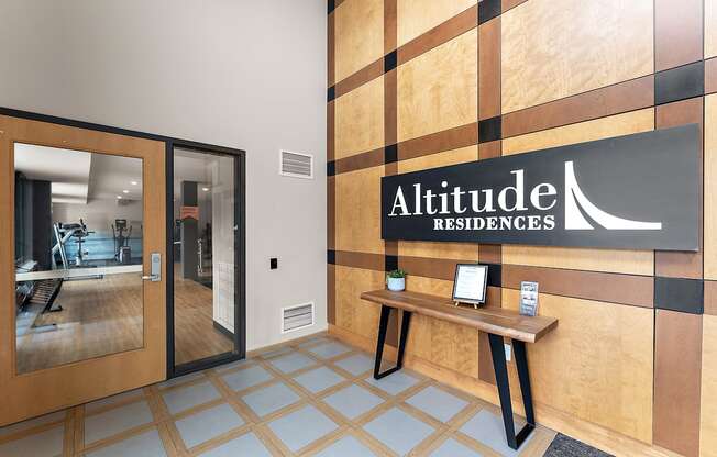 A lobby with Altitude Residences sign on the wall.