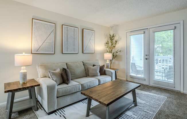 the living room of an apartment with a couch and a coffee table