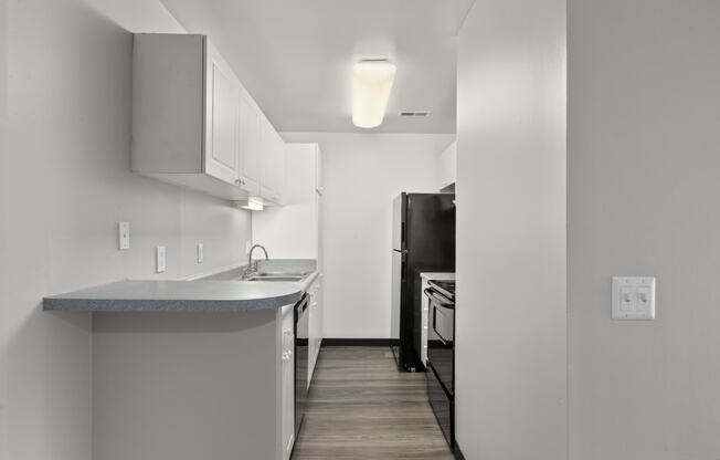 Kitchen with white cabinets and a black refrigerator at Creve Coeur, Creve Coeur, MO