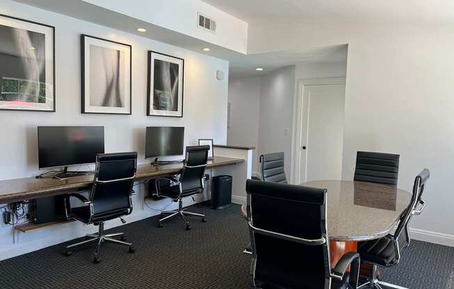 A conference room with a long table and chairs.