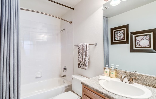 Model bathroom at our apartments in Antioch, featuring granite pattern countertops and a shower / bath combination.