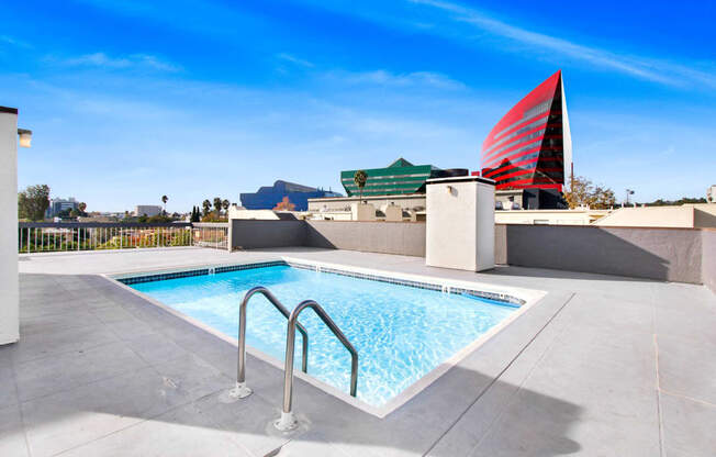 the pool is on the rooftop of a building with a sailboat on the roof