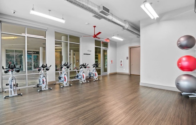 the gym with treadmills and exercise balls at the belgard apartments at South Side Flats, Dallas, 75215