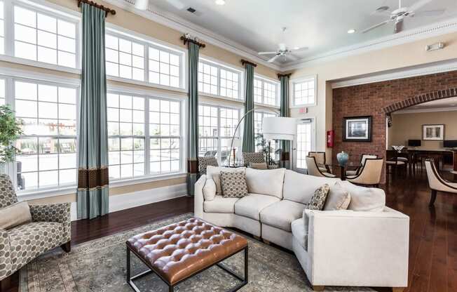 a living room with large windows and a white couch