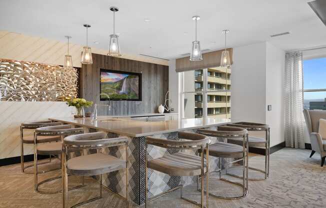 a kitchen with bar stools and a dining table