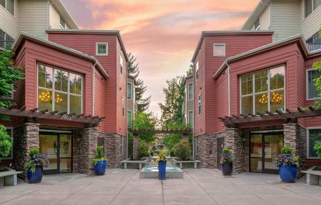 the courtyard of a condo building with a patio and potted plants at Delano, Redmond Washington