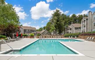 a swimming pool with apartment buildings in the background