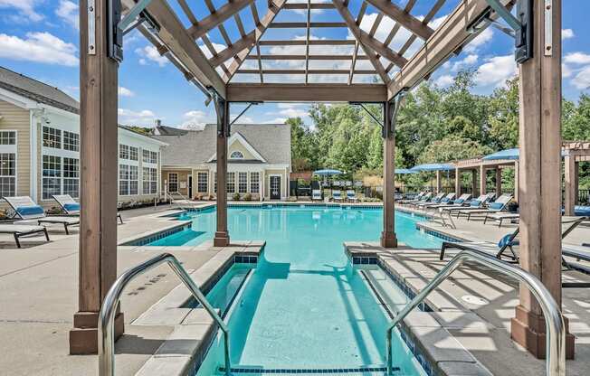 the resort style pool is surrounded by lounge chairs