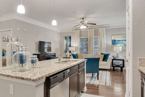 A kitchen with a counter and a fan.