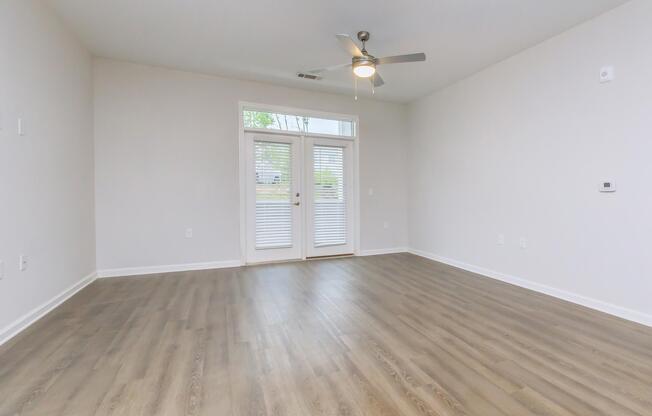 a living room filled with furniture and a large window