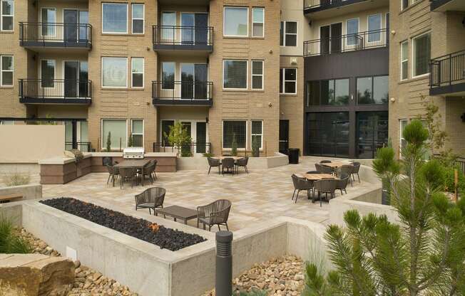 an open courtyard with tables and chairs in an apartment building